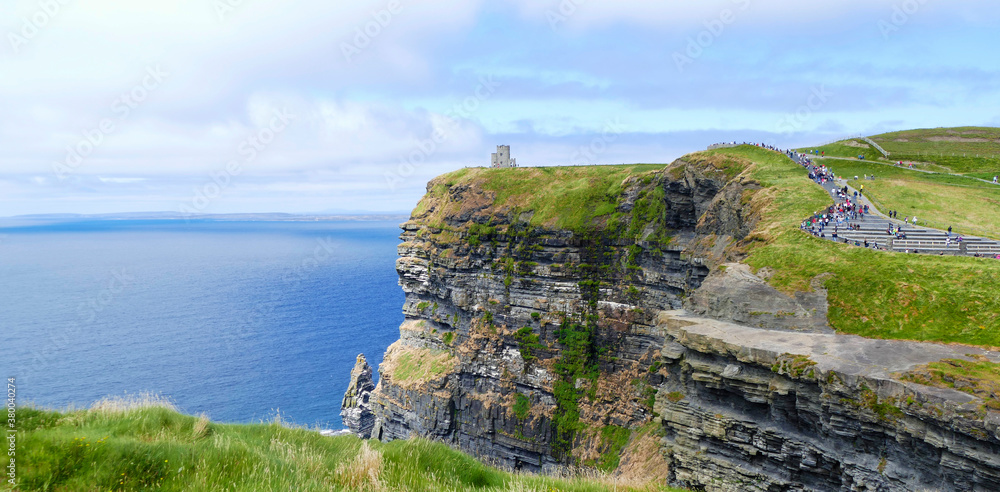 Cliffs of moher with the atlantic ocean, clouds and O Brien Tower