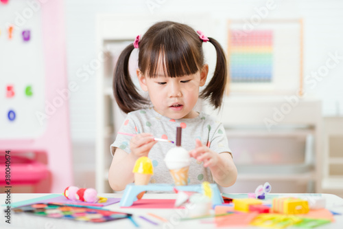 young girl decorating hand made craft for homeschooling