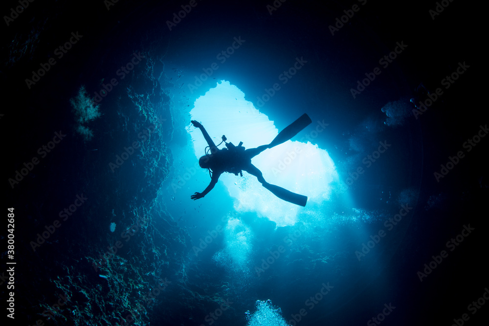 Scuba diver diving down to the blue hole Scuba diver diving down to the blue hole