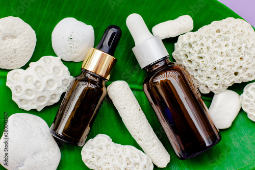 Cosmetic bottles on a lavender background.