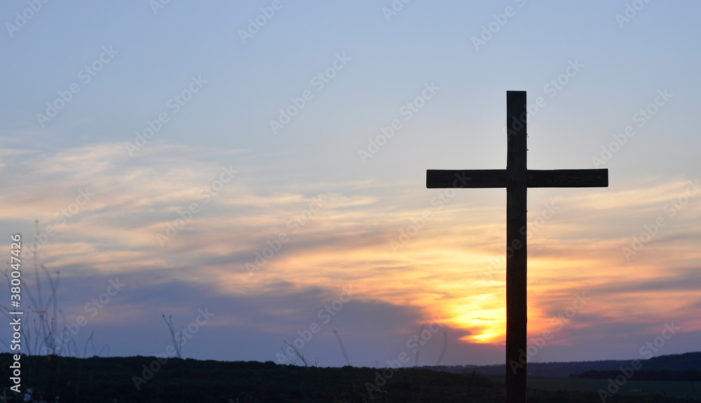  Cross of Jesus. Silhouette of a wooden cross on the background of the sunset