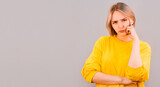 Portrait of an angry young casual woman isolated over gray background