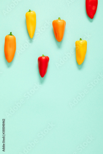 Vegetable on mint background. Pepper as background. Flat lay, top view, copy space