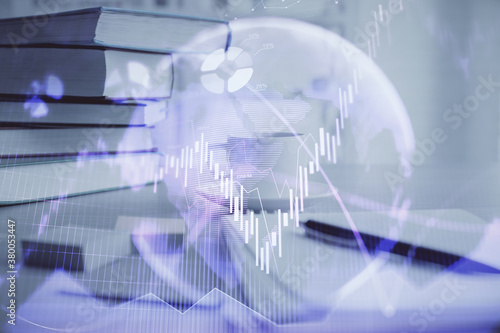 Double exposure of financial chart drawing and desktop with coffee and items on table background. Concept of forex market trading