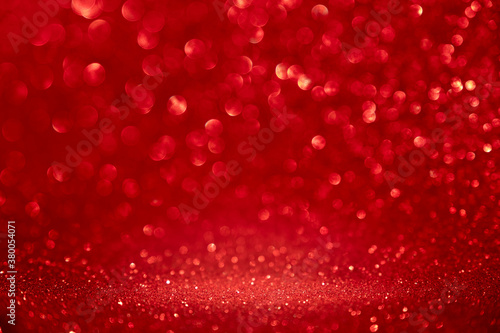 abstract red sparkling blurry background for Christmas or Valentine's day. Place to insert objects in the center.