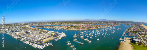 a breathtaking aerial shot of the skyline, deep blue ocean water, buildings and boats at Newport Beach Harbor in Newport Beach California 