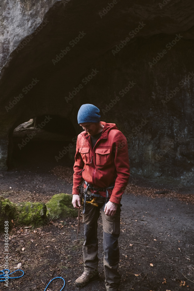 Man looking down at his climbing rope. Man looking down at his climbing rope.