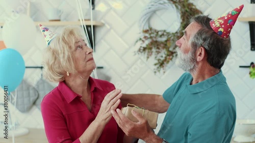 Wallpaper Mural Caucasian family. Happy birthday. Senior handsome man embracing his beautiful wife holding birthday presents congratulating having fun spending weekend at home. Torontodigital.ca