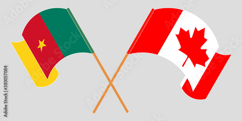 Crossed and waving flags of Cameroon and Canada