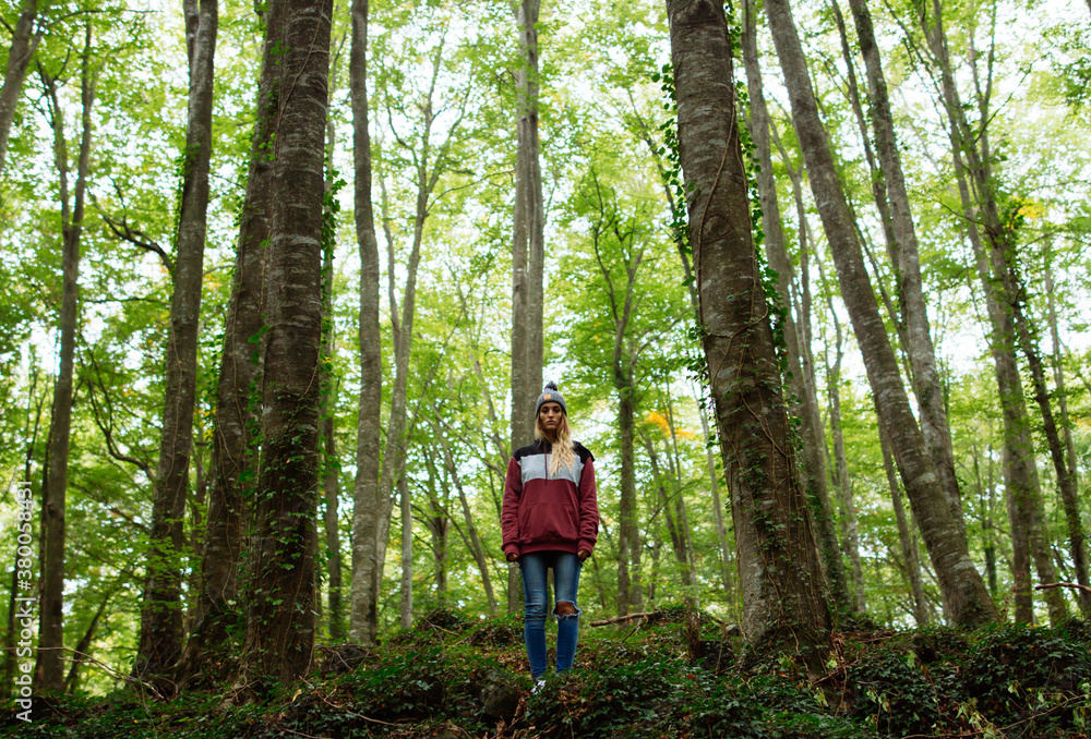 Portrait of woman in the forest between trees Portrait of woman in the forest between trees