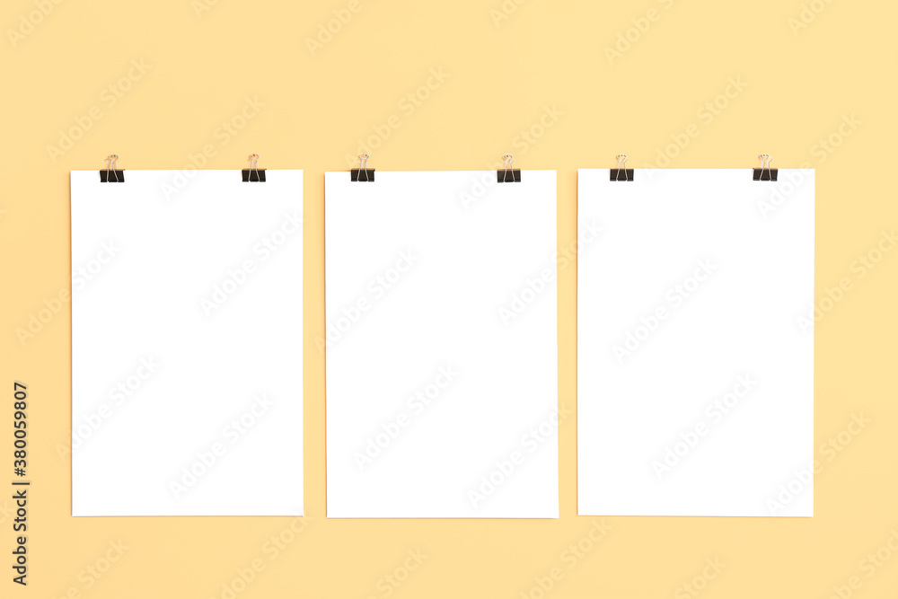 Blank posters hanging on color wall Blank posters hanging on color wall