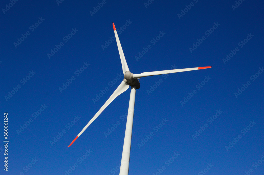 Wind generator with blue sky in the background Wind generator with blue sky in the background