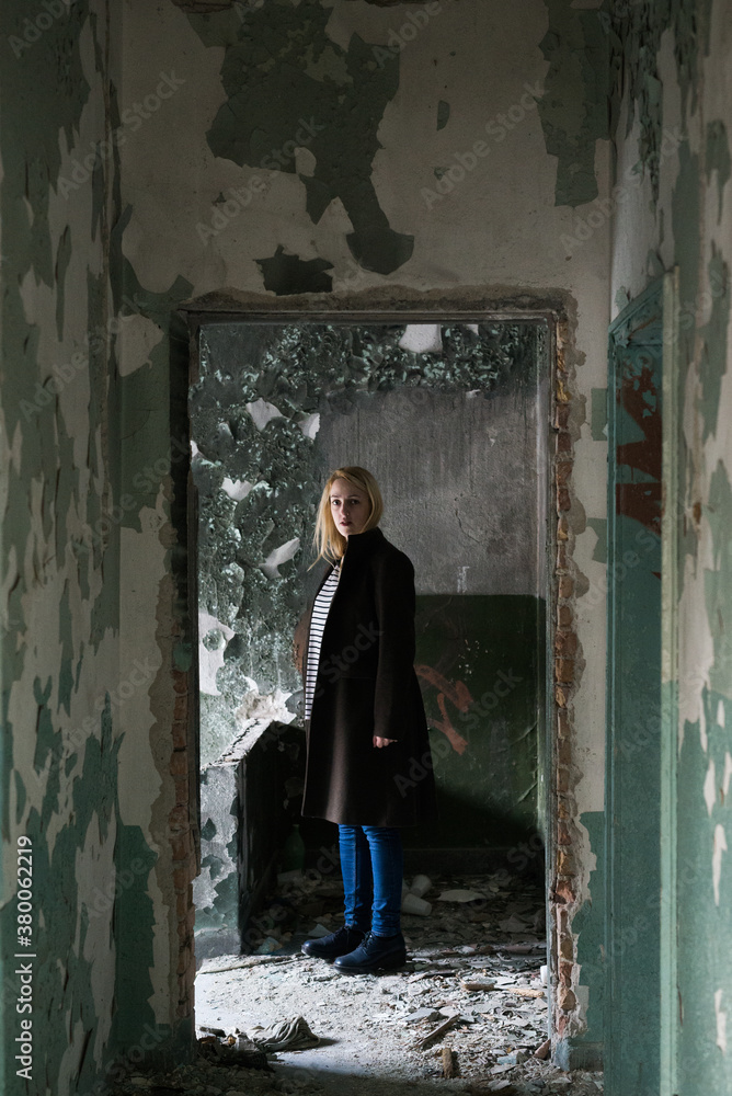 Young woman in an abandoned building Young woman in an abandoned building