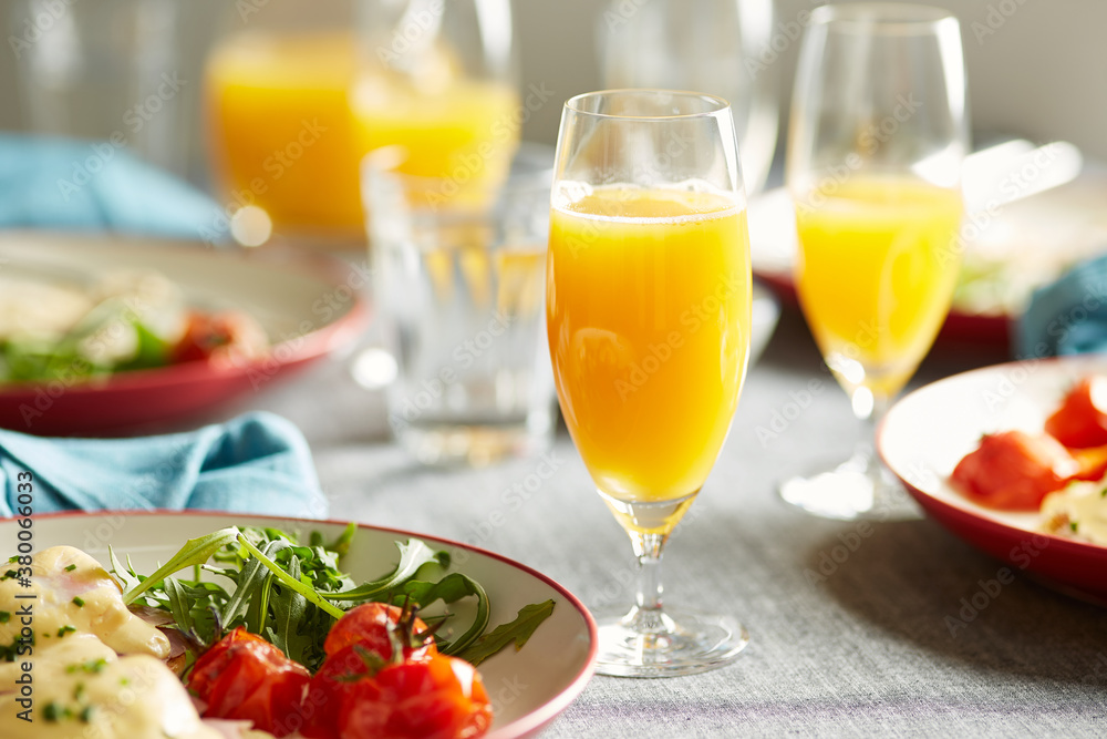 Delicious cocktail mimosa with plate of homemade breakfast. Delicious cocktail mimosa with plate of homemade breakfast.