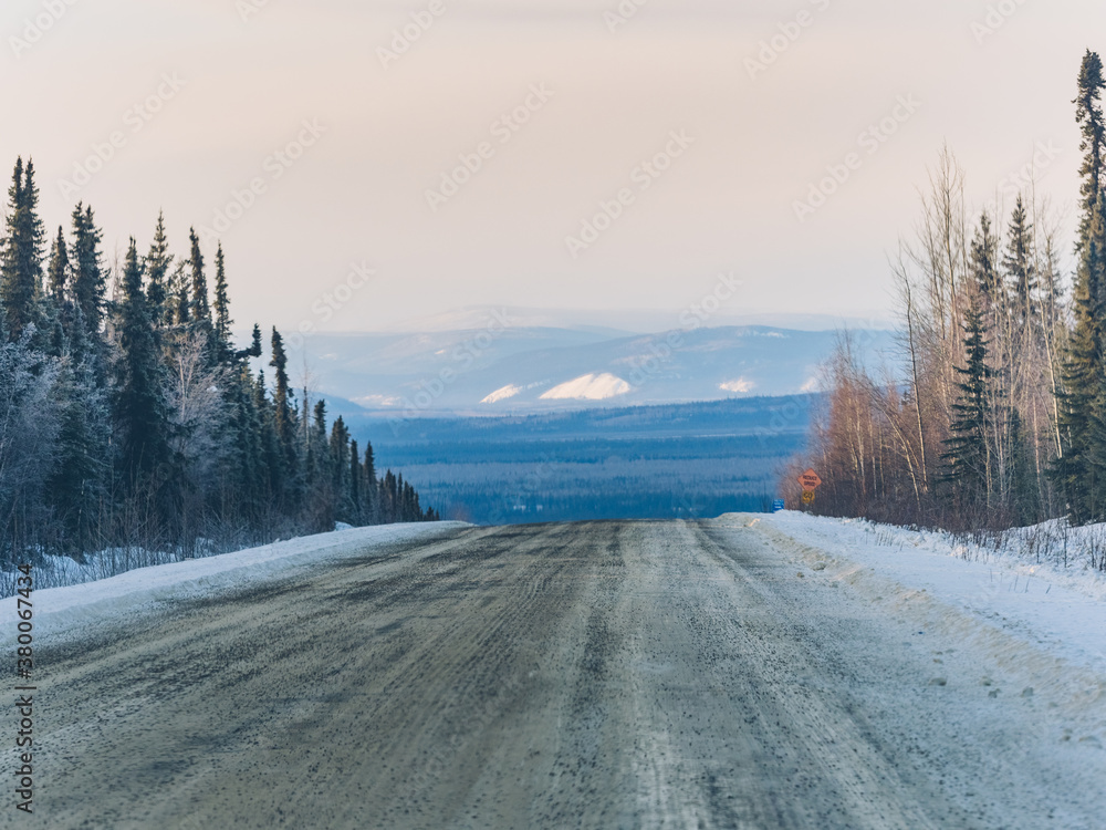 Empty snow-covered Alaska highway,Yukon,Canada. Empty snow-covered Alaska highway,Yukon,Canada.