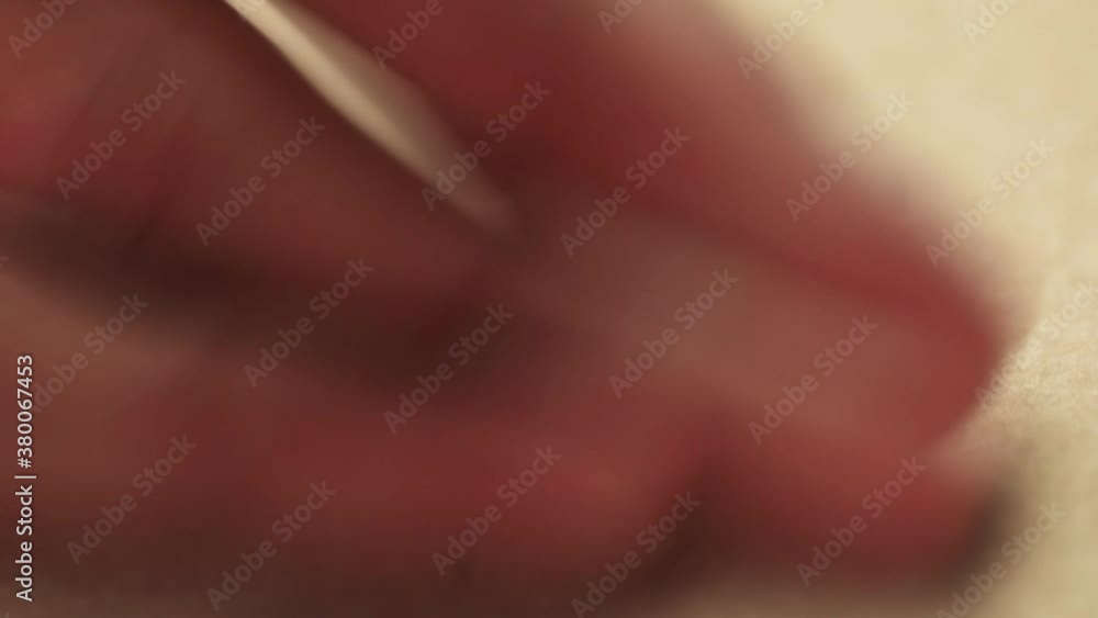 Close up of hand uses white eraser on kraft paper Close up of hand uses white eraser on kraft paper