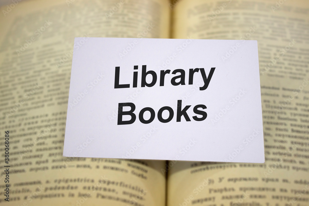 Library books written in white note on open books Library books written in white note on open books