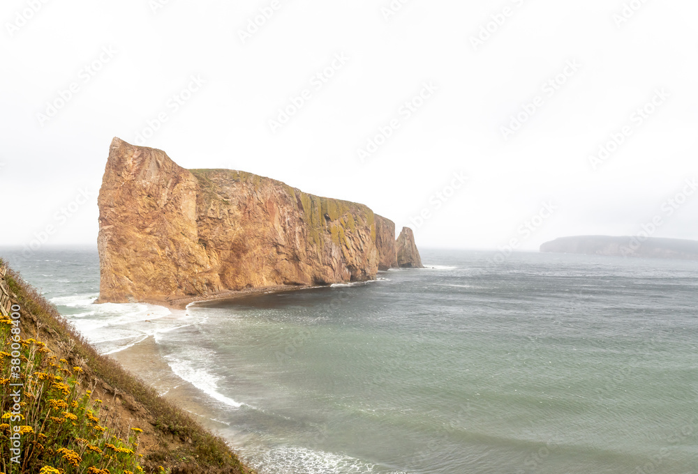 Dramatic view of the Percé rock, on the tip of the Gaspé Peninsula in Québec Dramatic view of the Percé rock, on the tip of the Gaspé Peninsula in Québec