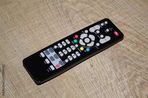 Television remote control on a wooden table