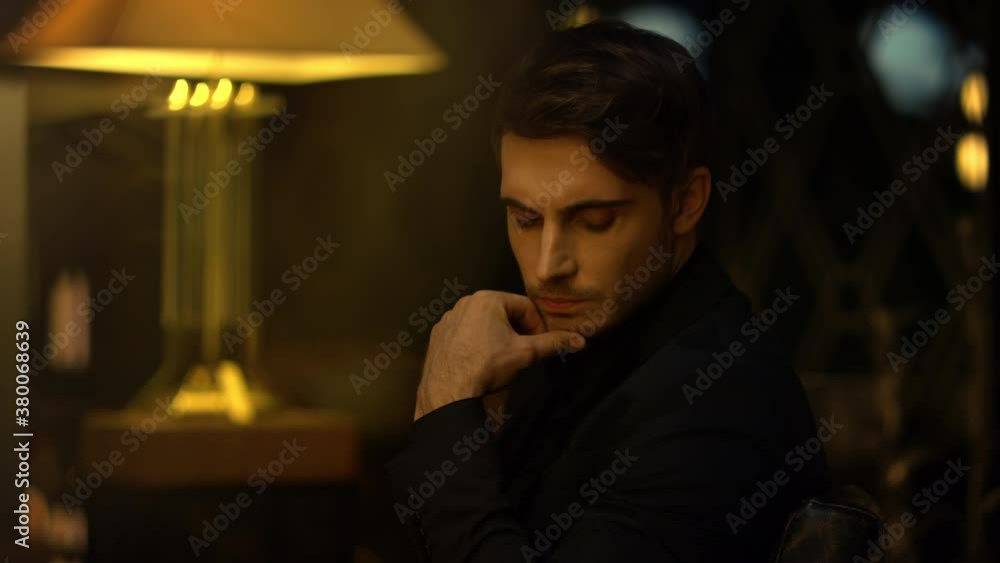 Focused top manager pondering in chair indoors. Serious man touching chin. Focused top manager pondering in chair indoors. Serious man touching chin.