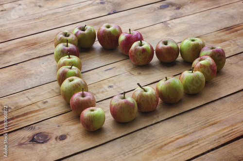 Heart of apples. Fresh organic apples on the rustic wodeen background. Apples heart. Love Concept. The autumn concept. Diet concept photo