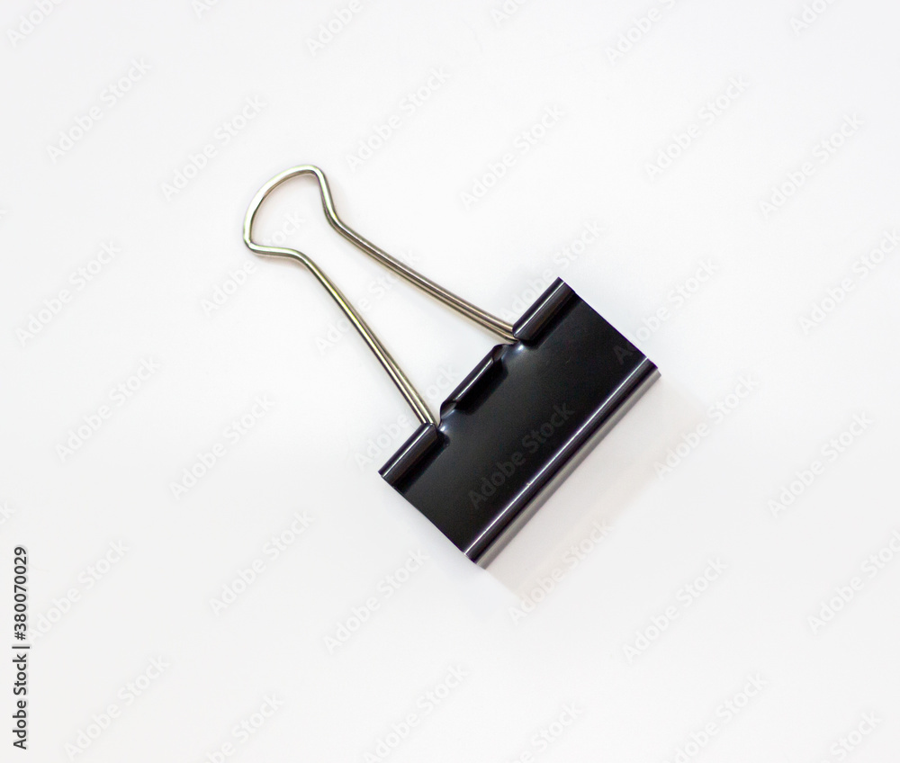 Clip for papers. Binding of papers, office supplies. Binder for papers on a white background. Clip for papers. Binding of papers, office supplies. Binder for papers on a white background.