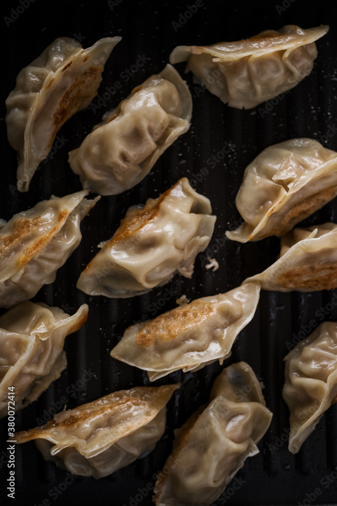 Chinese food pot stickers in a pan Chinese food pot stickers in a pan