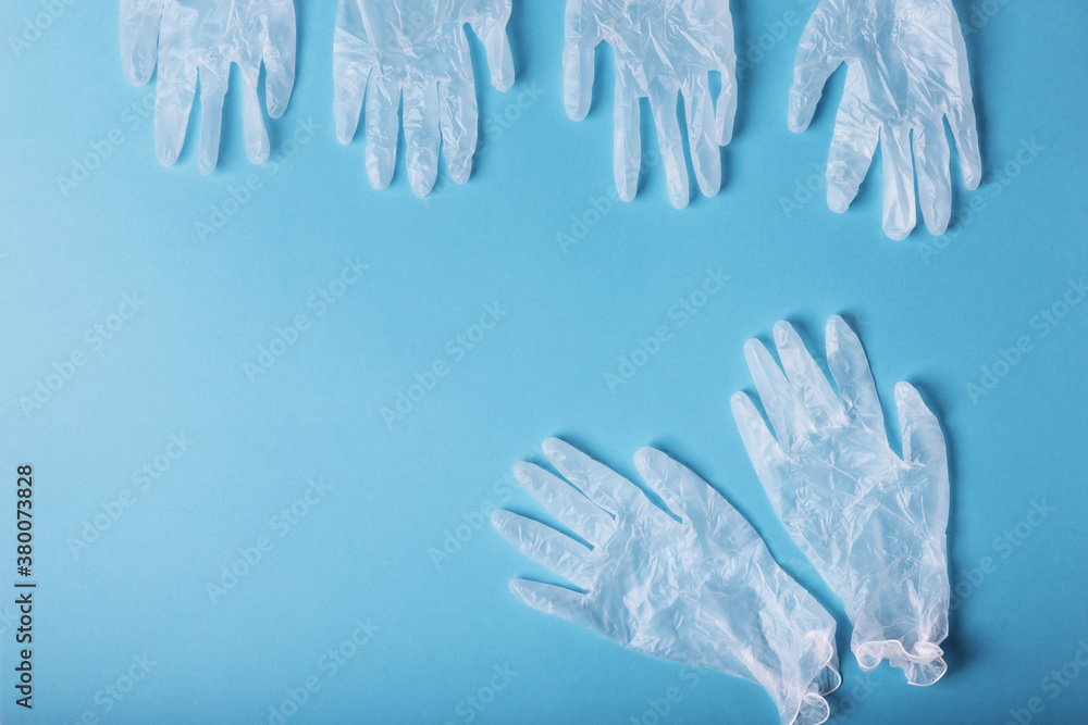Whitte surgical gloves isolated on the blue background. Concept protect against infection or contamination Whitte surgical gloves isolated on the blue background. Concept protect against infection or contamination