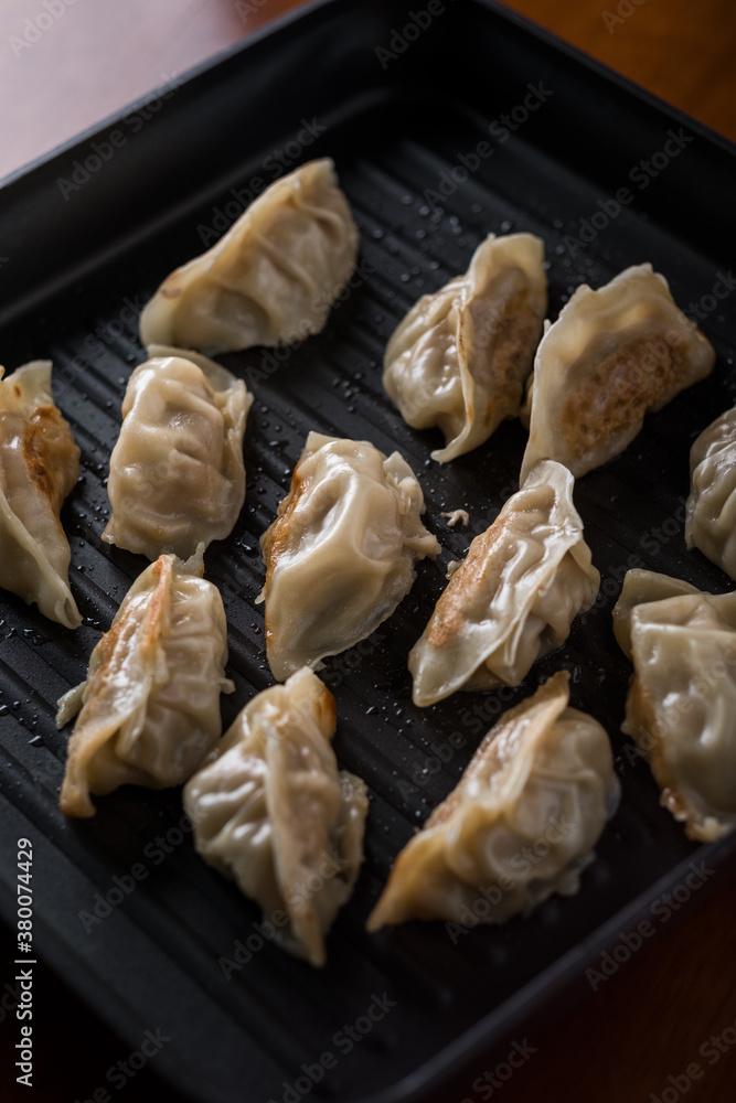 Chinese food pot stickers in a pan Chinese food pot stickers in a pan