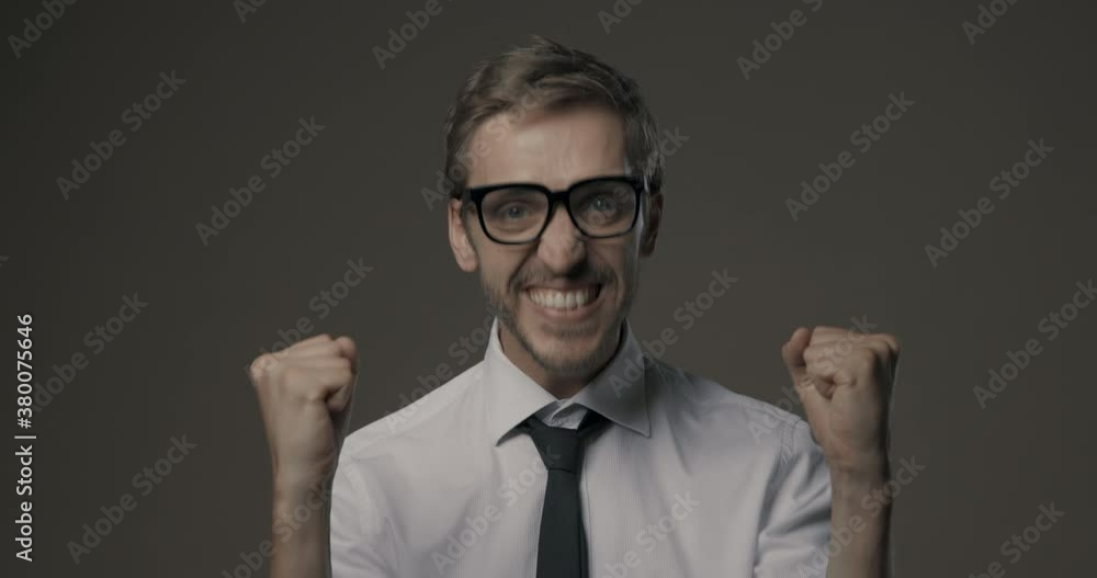 Cheerful happy man celebrating with raised fists Cheerful happy man celebrating with raised fists