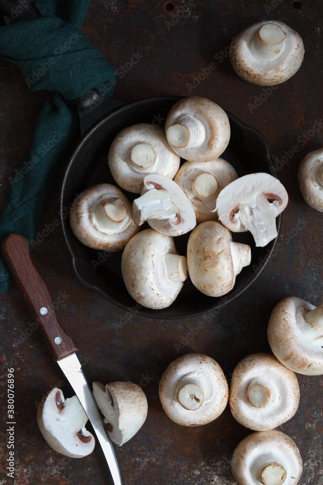 Fresh champignons in a frying pan at the kitchen prepared to cook