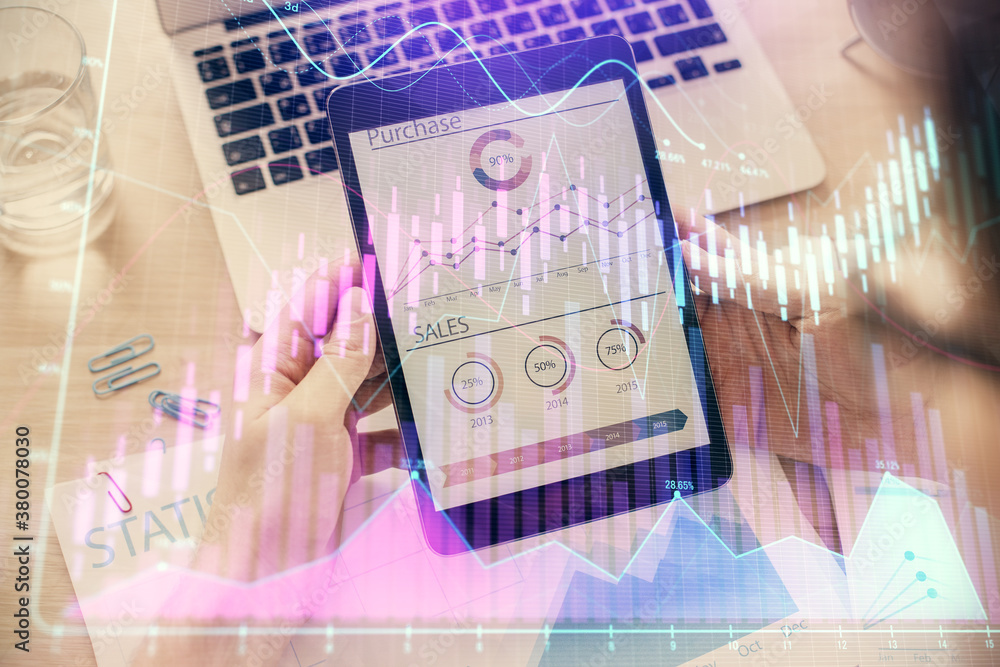Double exposure of man's hands holding and using a digital device and forex graph drawing. Financial market concept. Double exposure of man's hands holding and using a digital device and forex graph drawing. Financial market concept.