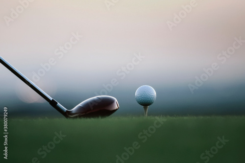 Golf Ball on Tee at Dawn with Driver Club