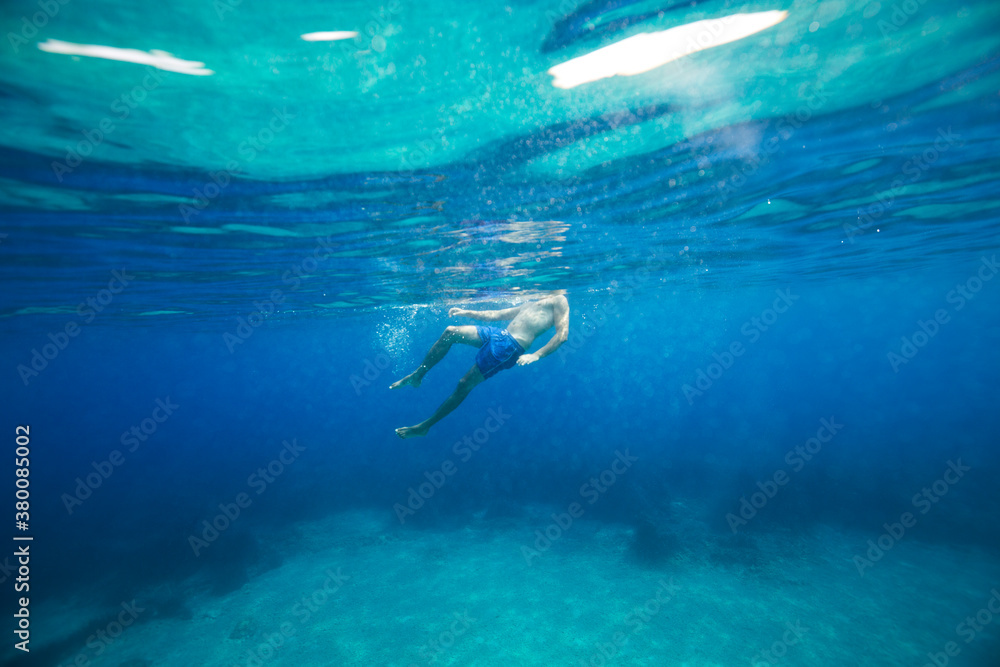 Man resting on the sea surface Man resting on the sea surface