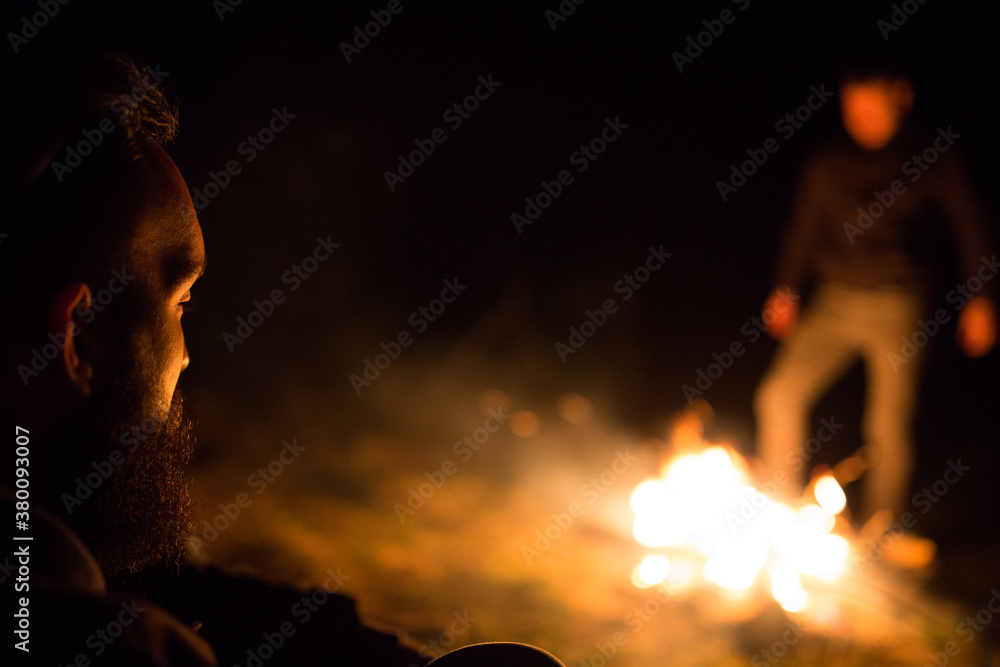Man sitting next to the campfire Man sitting next to the campfire