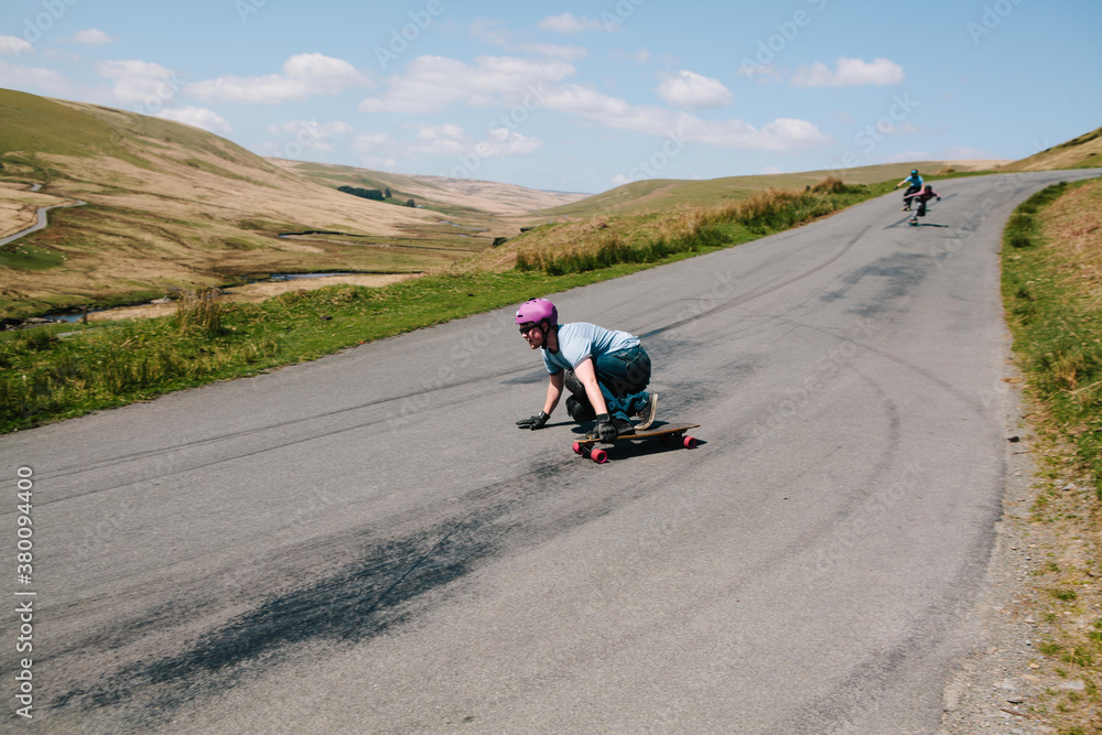 Male longboarder preparing to take a turn Male longboarder preparing to take a turn