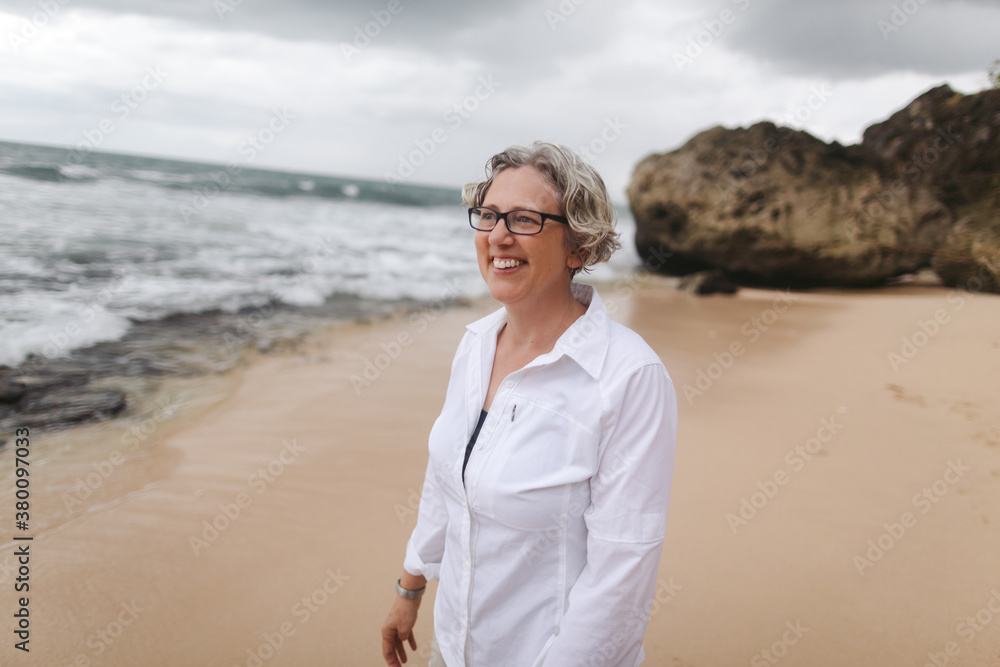 Happy, energetic older woman on tropical beach Happy, energetic older woman on tropical beach