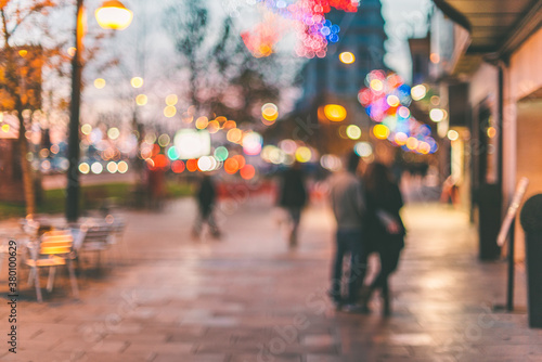 Unfocused young couple watching the Christmas decorations on the street. photo