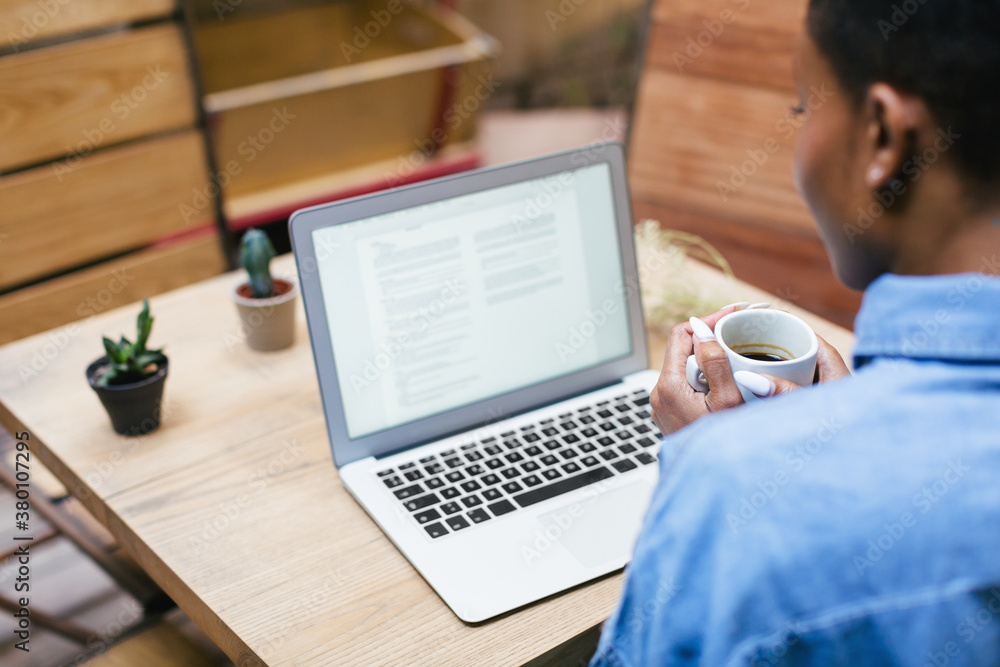Portrait of an african american woman working with laptop at home. Portrait of an african american woman working with laptop at home.