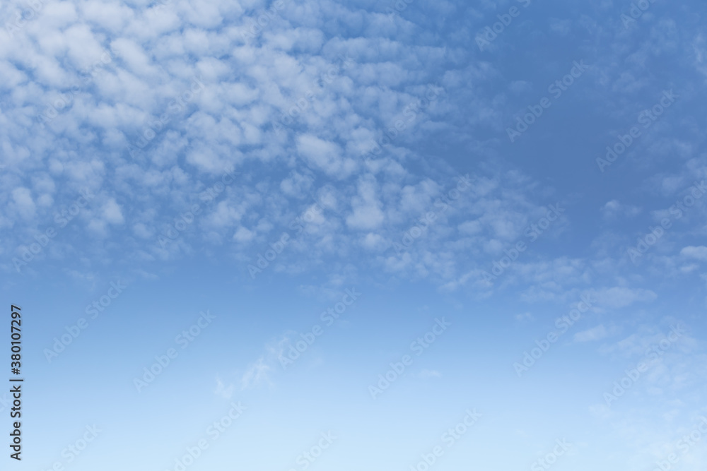 Beautiful fluffy white clouds float in the blue sky on a nice day in summer. Blue is the beautiful color of nature. Beautiful fluffy white clouds float in the blue sky on a nice day in summer. Blue is the beautiful color of nature.