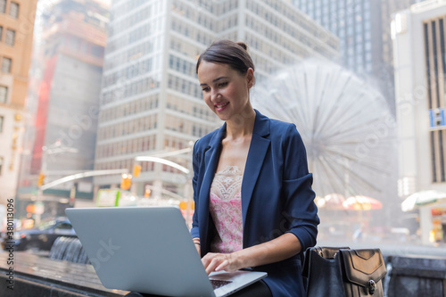 Wallpaper Mural Young Businesswoman Working With a Laptop in Manhattan . New Yor Torontodigital.ca