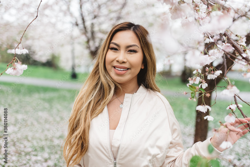 A young asian woman amongst cherry blossoms in the spring A young asian woman amongst cherry blossoms in the spring