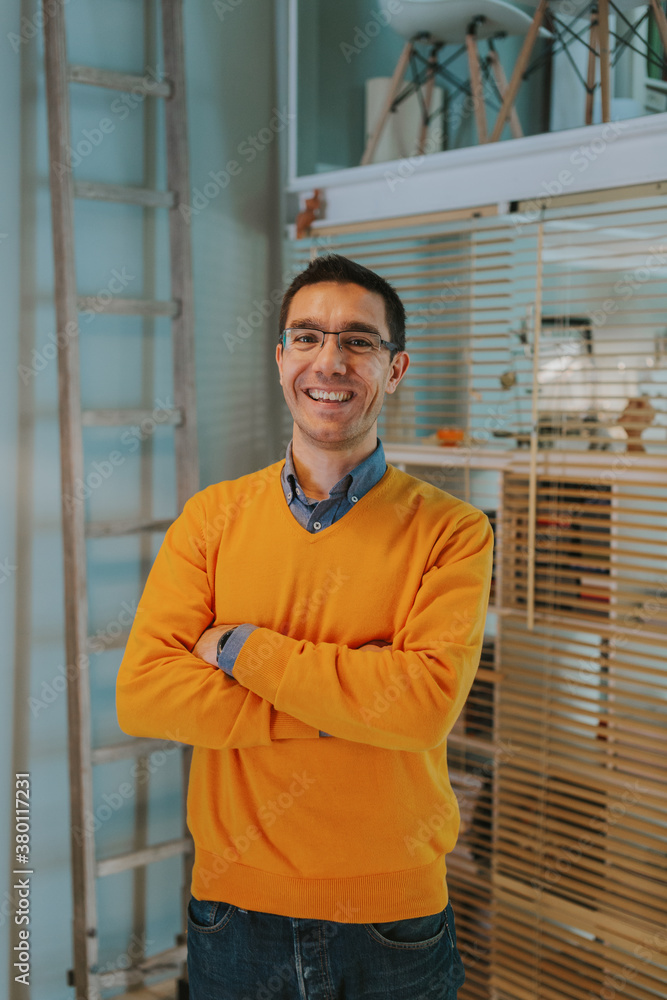 Casual architect with orange sweater in his studio Casual architect with orange sweater in his studio