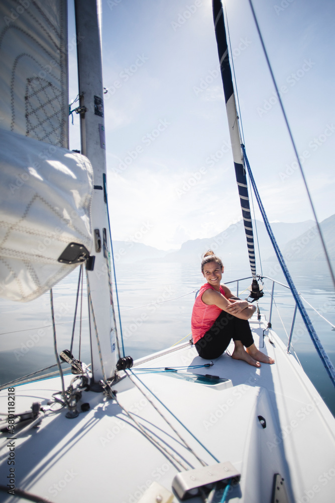 Smiling woman relaxes on a sail boat Smiling woman relaxes on a sail boat