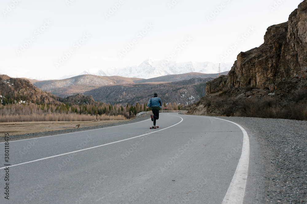 Man on skateboard on empty road Man on skateboard on empty road