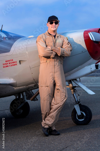 Fighter pilot standing next to Marchetti SIAI SF260 fighter propeller airplane  - Vertical photo