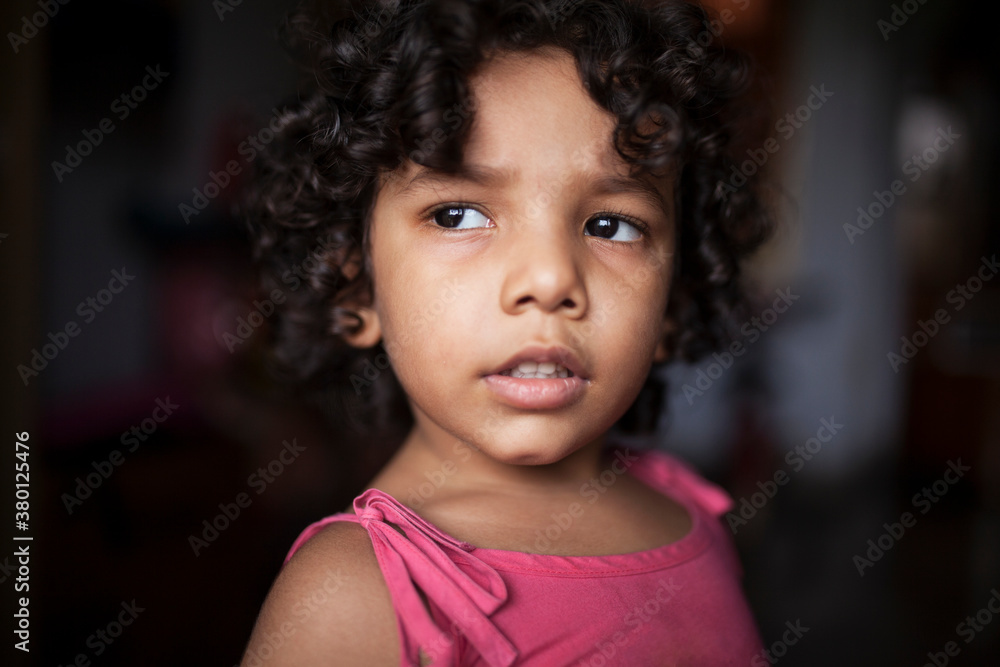 Portrait of a kid looking beyond camera Portrait of a kid looking beyond camera