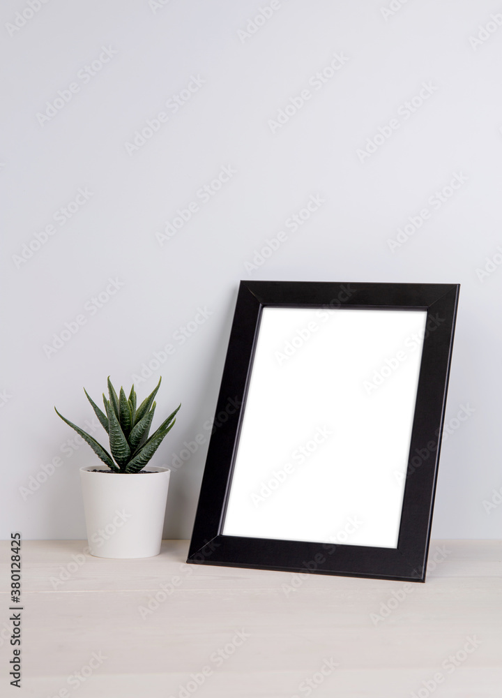 Mockup frame and plants in pot on table top at home, mock up poster for presentation on desk, indoor, your design for gallery photo and picture, border template and decoration for advertising. Mockup frame and plants in pot on table top at home, mock up poster for presentation on desk, indoor, your design for gallery photo and picture, border template and decoration for advertising.
