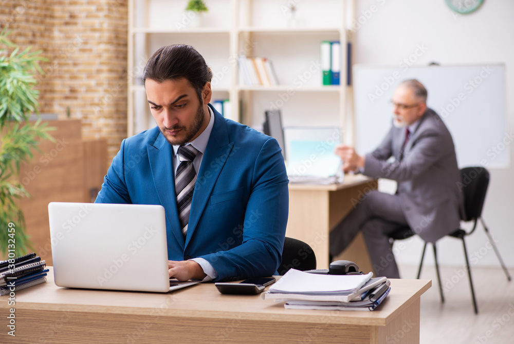 Two male colleagues working in the office Two male colleagues working in the office