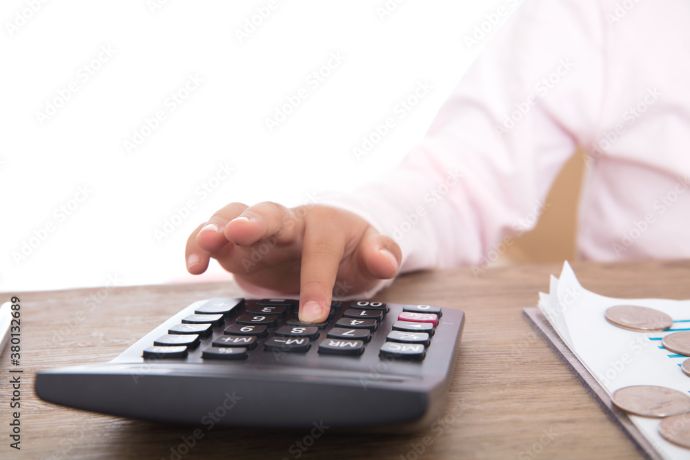 Child's hand is using calculator Child's hand is using calculator